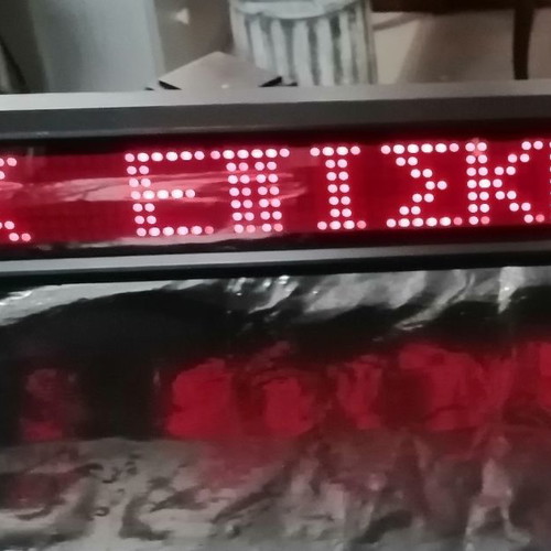 Electronic sign with running letters and clock used, 106x11 cm