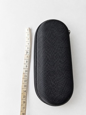 Black hard-shell glasses case with zip closure