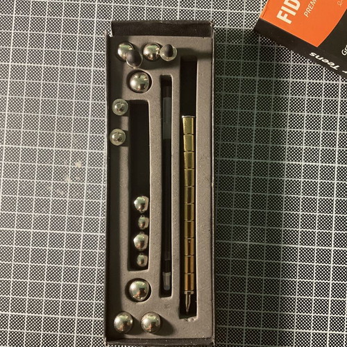 Gold Fidget Pen used with magnetic parts and two ink refills