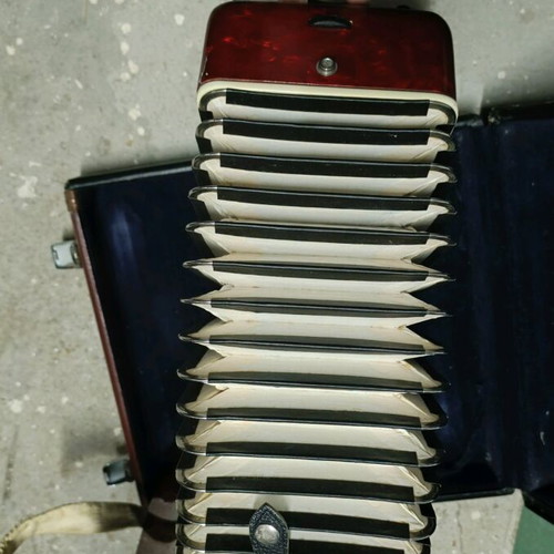 Accordion piano type with red pearlescent lid in case