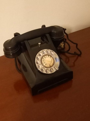 Antique phone used, black with rotary dial