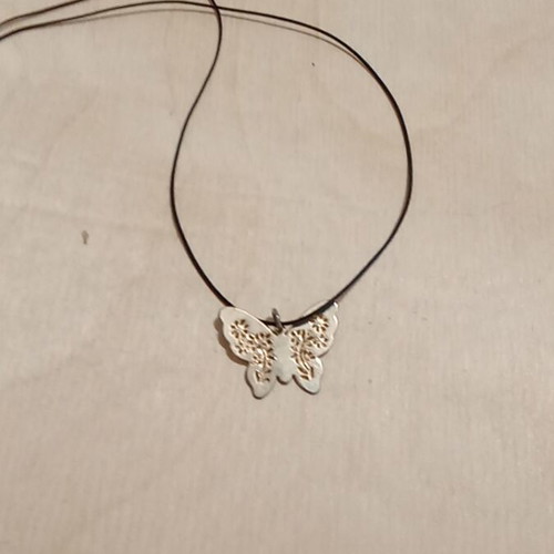 Butterfly pendant used, metallic gold with synthetic silk cord
