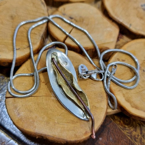 Silver handmade jewelry used with mixed materials leaf design