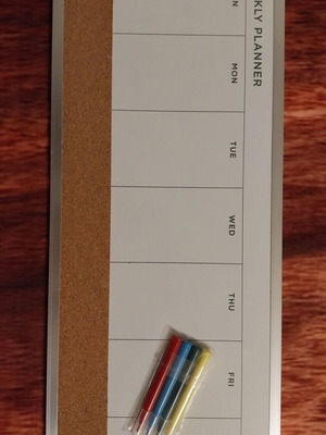 Weekly planner used with markers and cork board