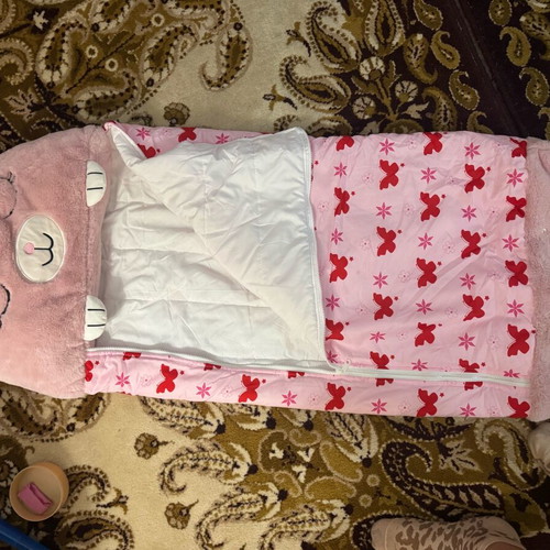 Sleeping bag used, foldable with one button missing