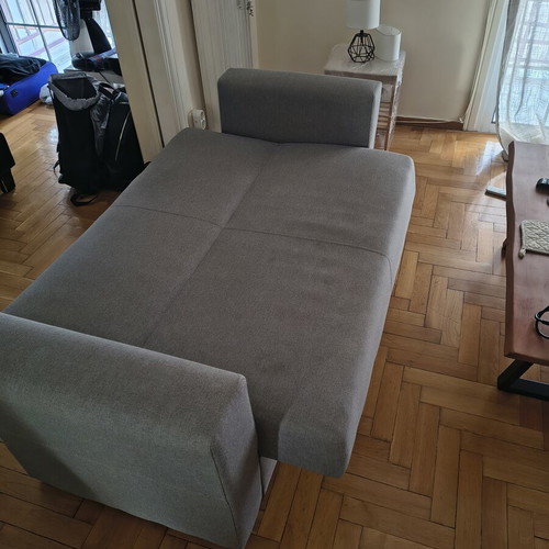 Two-seater sofa with storage and bed function