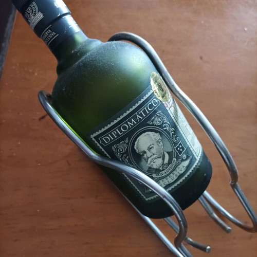 Bottle holder stainless like new with collectible rum bottle