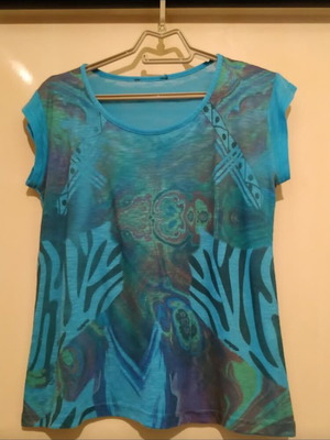 Blue short-sleeve blouse with printed designs used