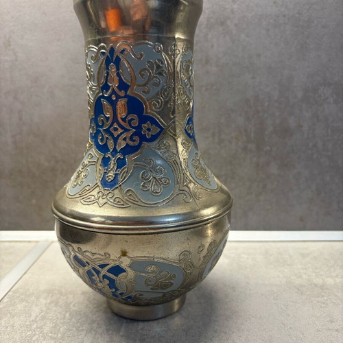 Vintage metal vase used with embossed designs and blue details