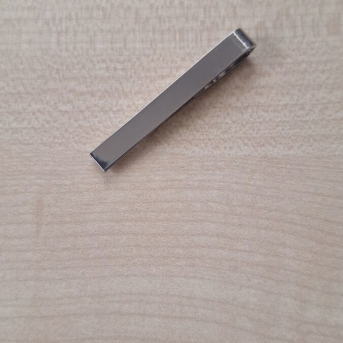 Silver tie clip used, gray