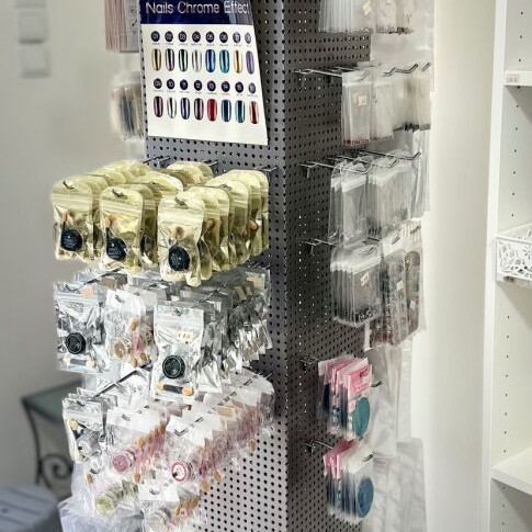 Perforated metal rotating stand like new with 82 hooks