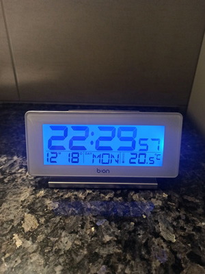 Digital table clock used with thermometer and alarm