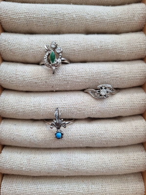 3 rings with blue, green and white stones
