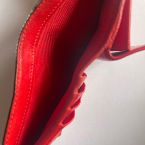 Christian Louboutin wallet used with missing spike and black stains