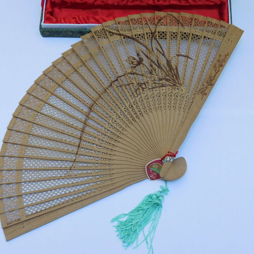 Traditional Chinese sandalwood fan with decorative tassel