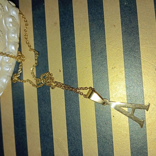 Monogram necklace new, gold color