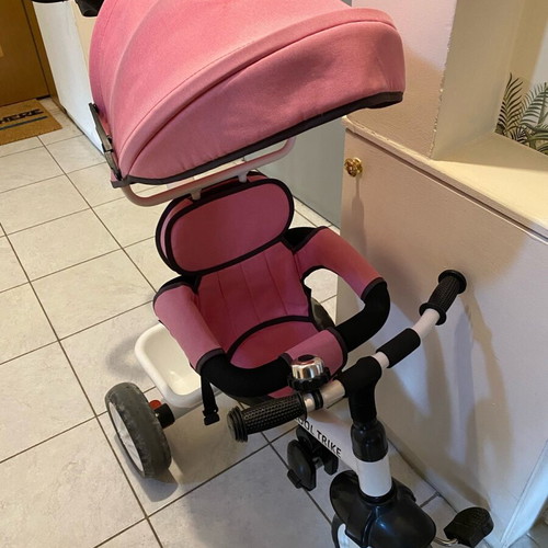 Tricycle pink with parent-controlled steering used