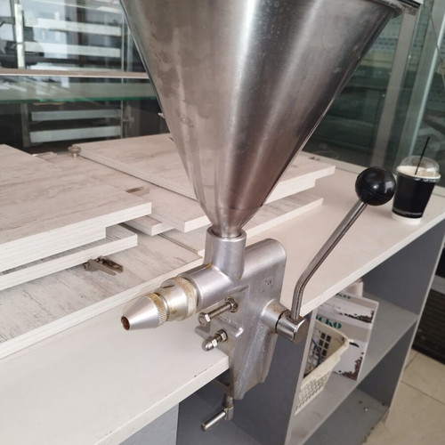 Manual dough depositor with stainless steel hopper and lever