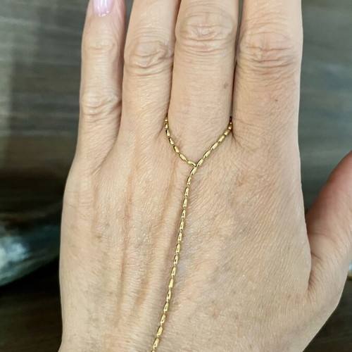 Hand chain in gold tone stainless steel, new