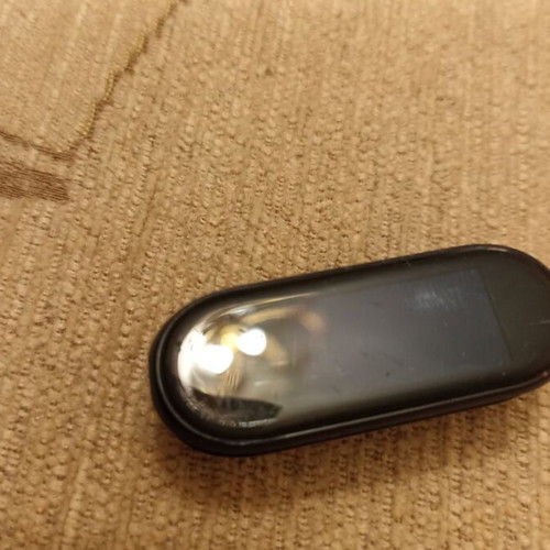 Mi Band smart watch used with charger, strap needs replacement