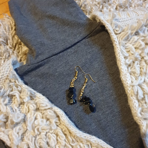 Grey turtleneck top, beige sleeveless fur vest and black stone earrings set