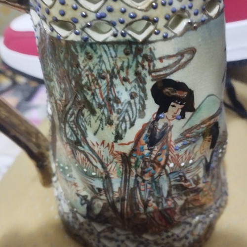 Collectible ceramic pitcher with embossed decorations, new