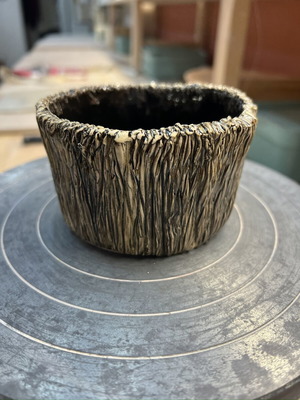 Handmade ceramic bowl with embossed design and black interior