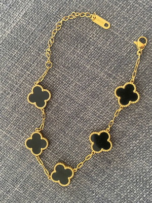 Bracelets used, white and black with gold