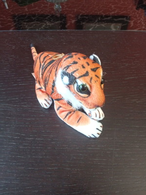 Tiger plush toy used with black stripes on orange fur