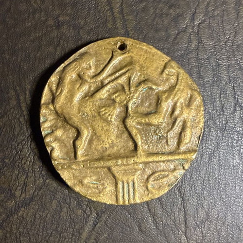 Metal collectible pendant with embossed classical motif, new