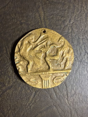 Metal collectible pendant with embossed classical motif, new