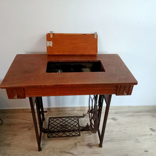 Antique sewing machine used with furniture and accessories