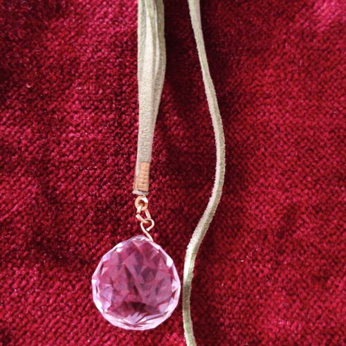 Asymmetric long necklace with green suede cord, crystal & CC motif used
