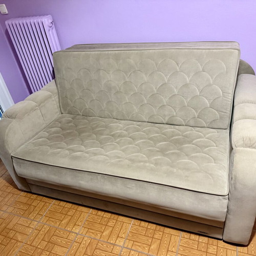Two-seater sofa light brown/grey like new, folds into a bed