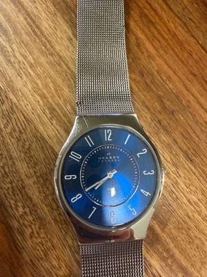 Skagen watch used with blue dial and silver bracelet