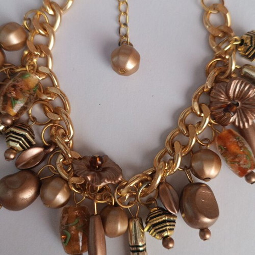 Gold bracelet with various charms handmade from scratch
