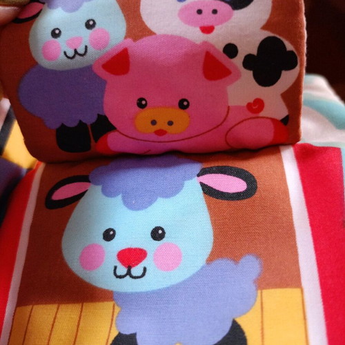 Cow toy for stroller or vintage rattle with sounds and textures