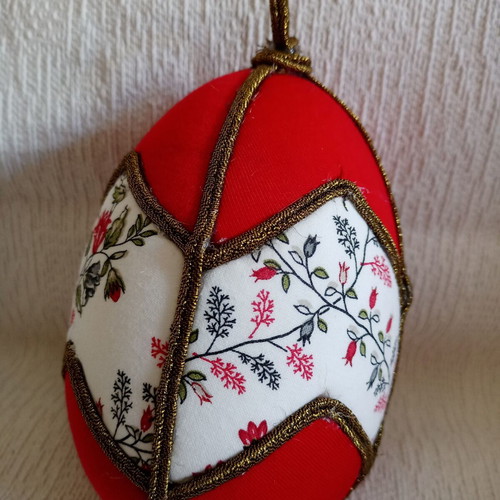 Decorative red egg used with geometric design and bronze border