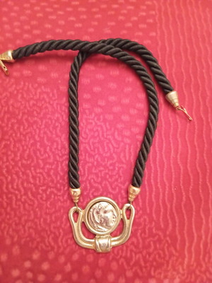 Necklace like new with black cord and gold details