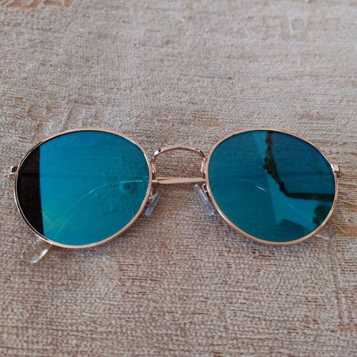 Sunglasses with blue mirror lenses and gold frame