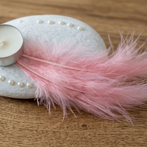 Handmade decorative candle on stone with pink feathers new