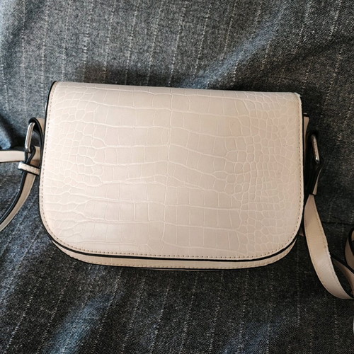 Beige crossbody bag used with adjustable strap