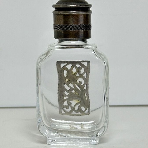 Vintage glass perfume bottle with metal decoration