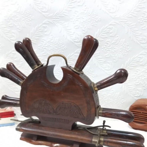 Wooden carved stand with used set of knives and forks