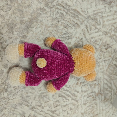 Amigurumi knitted teddy bear with velvet pajamas and sleep hat