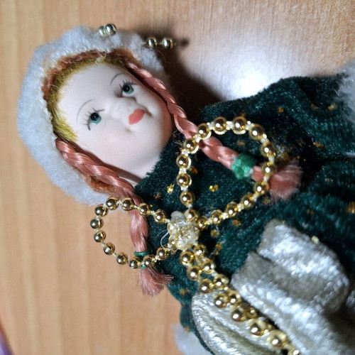 Porcelain doll on stand like new