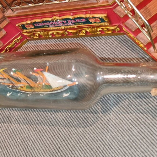 Ship in a bottle used with sealed top and wooden base