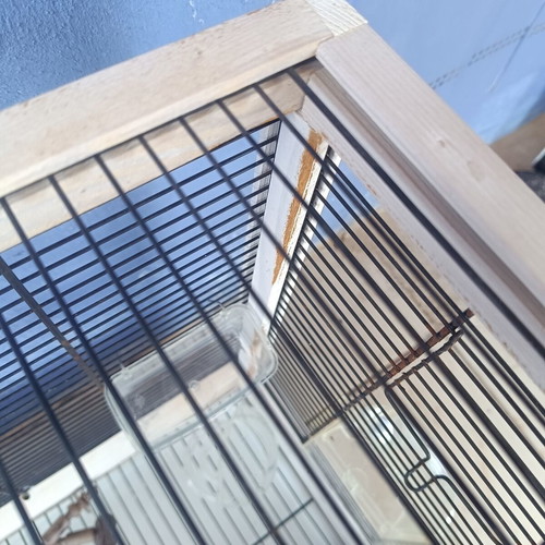 Wooden birdcage used with steel bars and plastic door
