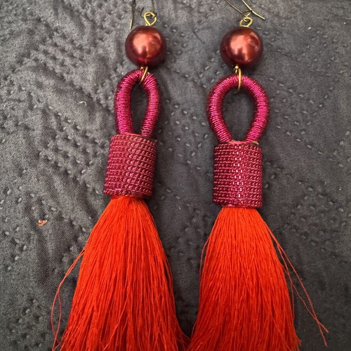 Red earrings with intricate binding and tassel like new