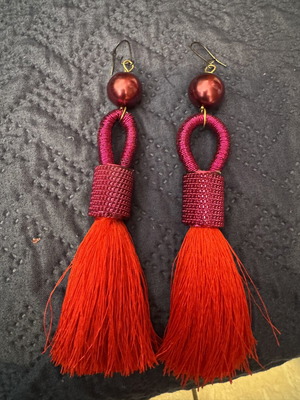 Red earrings with intricate binding and tassel like new